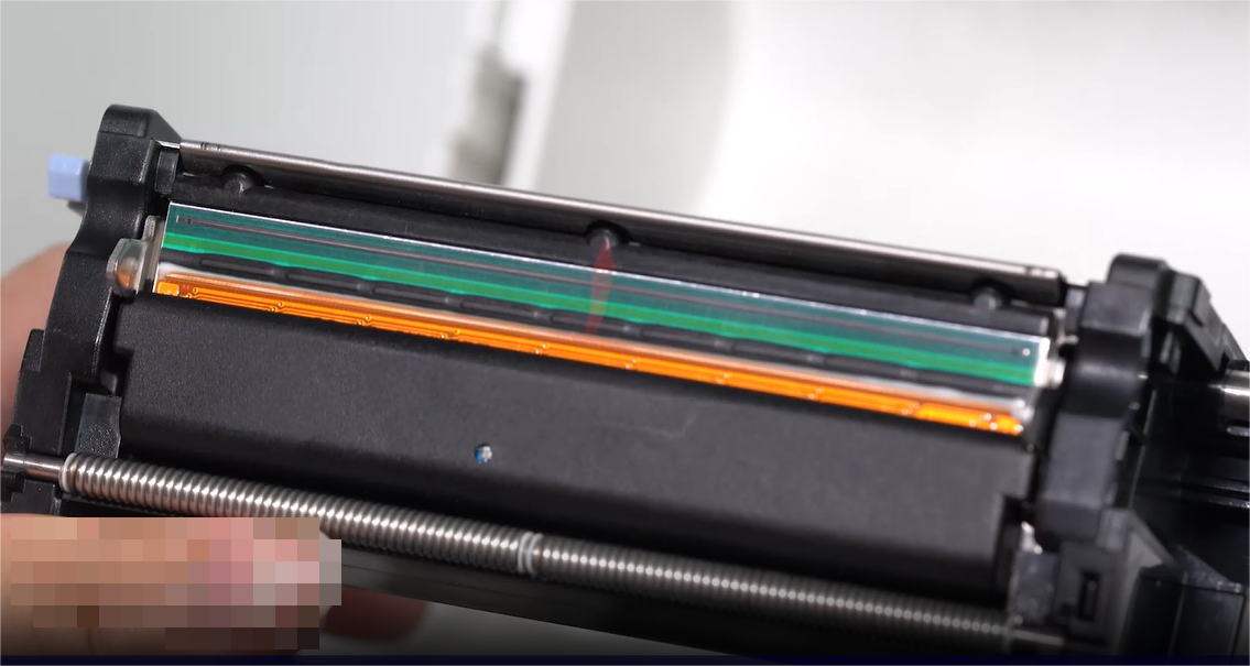 Α close-up of a person carefully cleaning an electronic component with a swab.