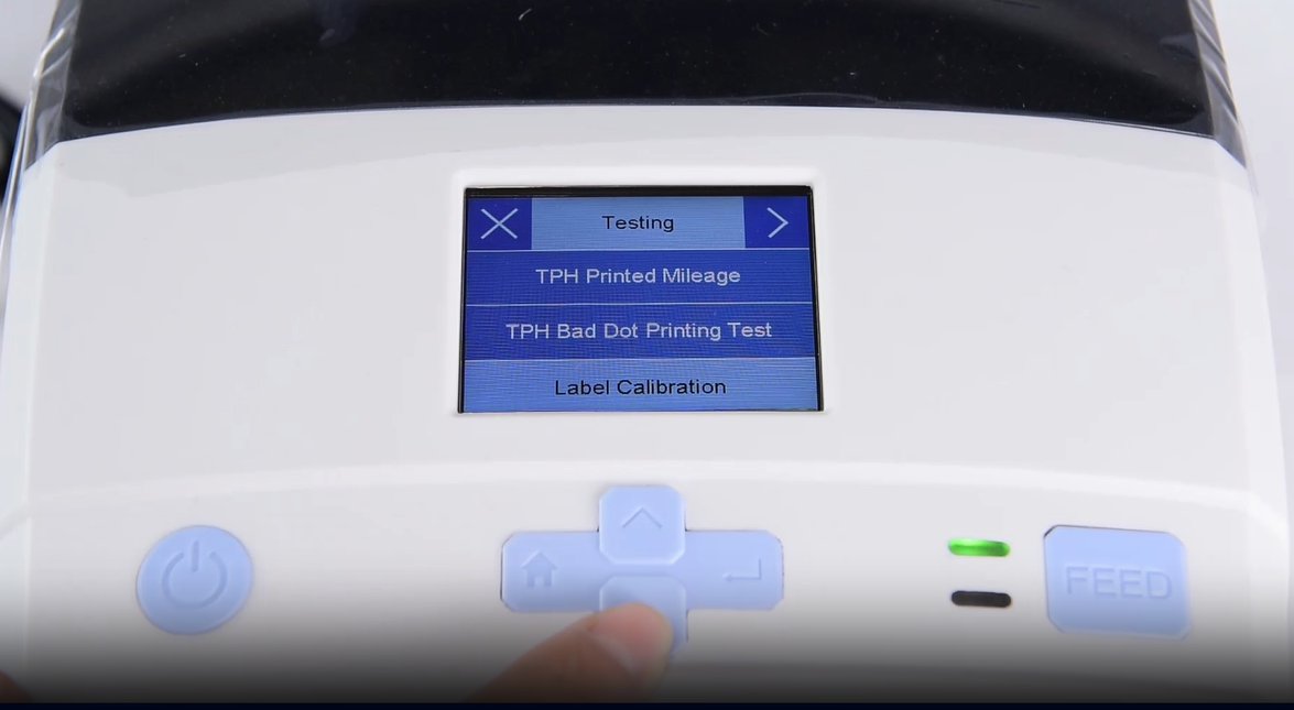 Α close-up of a machine's digital interface showing a testing menu.